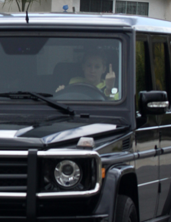 Ashley Tisdale fait signe de la main aux paparazzi